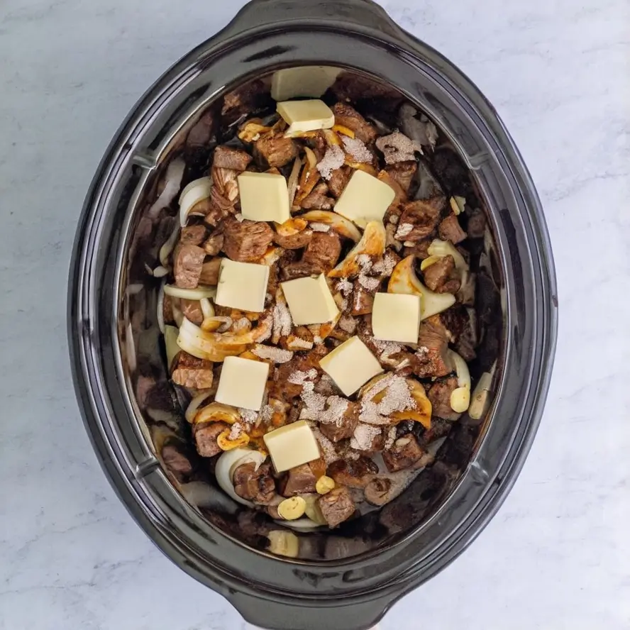 preparing slow cooker garlic butter beef.